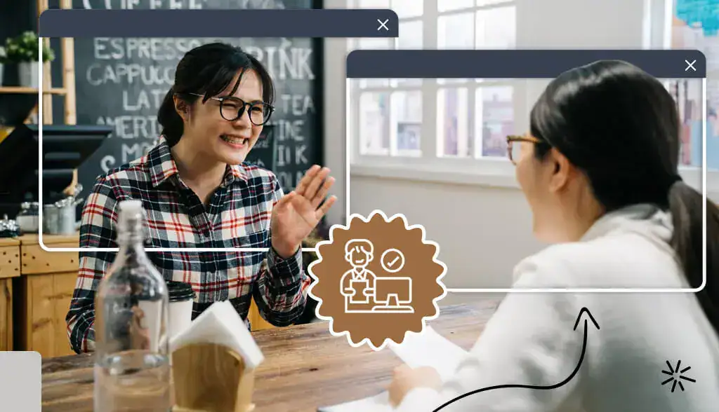 Two women sitting at a table in a small business